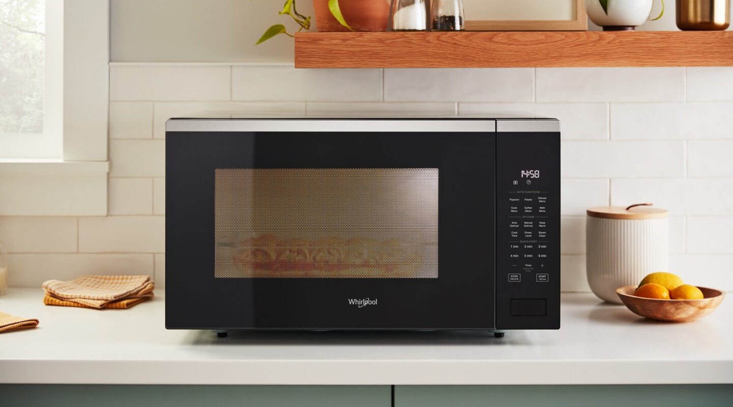 A Whirlpool brand countertop microwave in a modern kitchen
