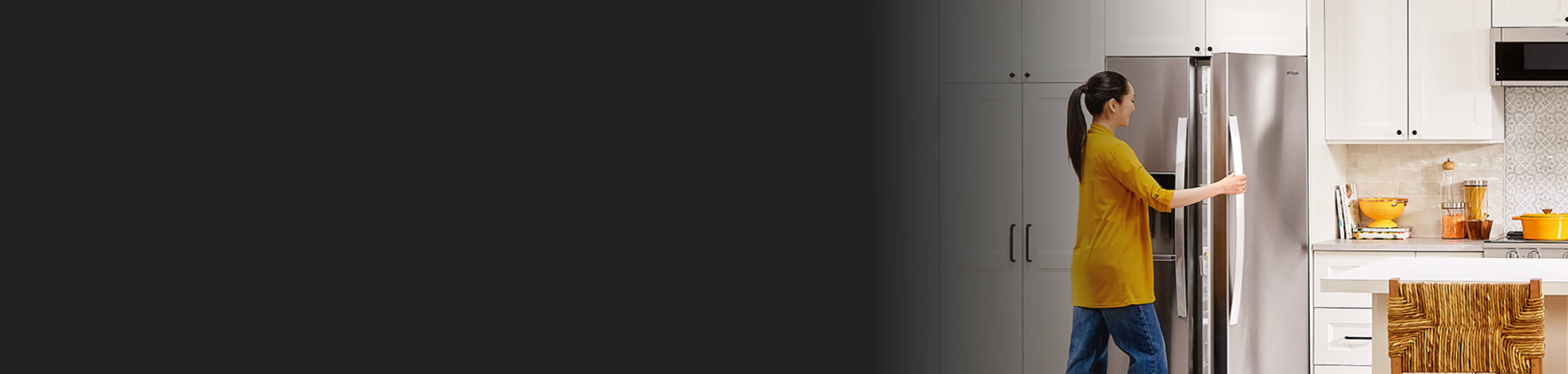 Person opening a stainless steel refrigerator