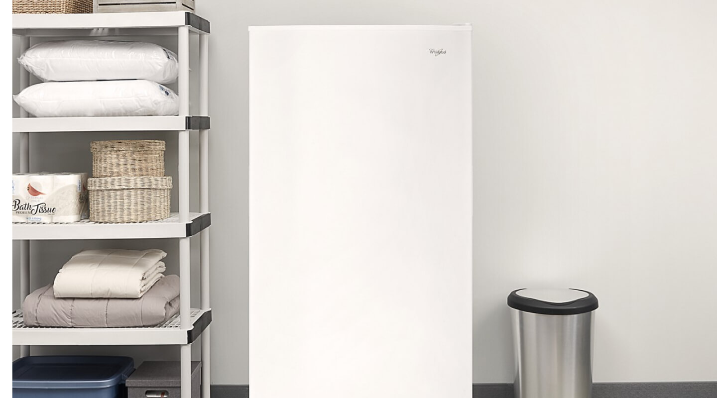 White Whirlpool® Upright Freezer along garage wall White Whirlpool® Upright Freezer along garage wall