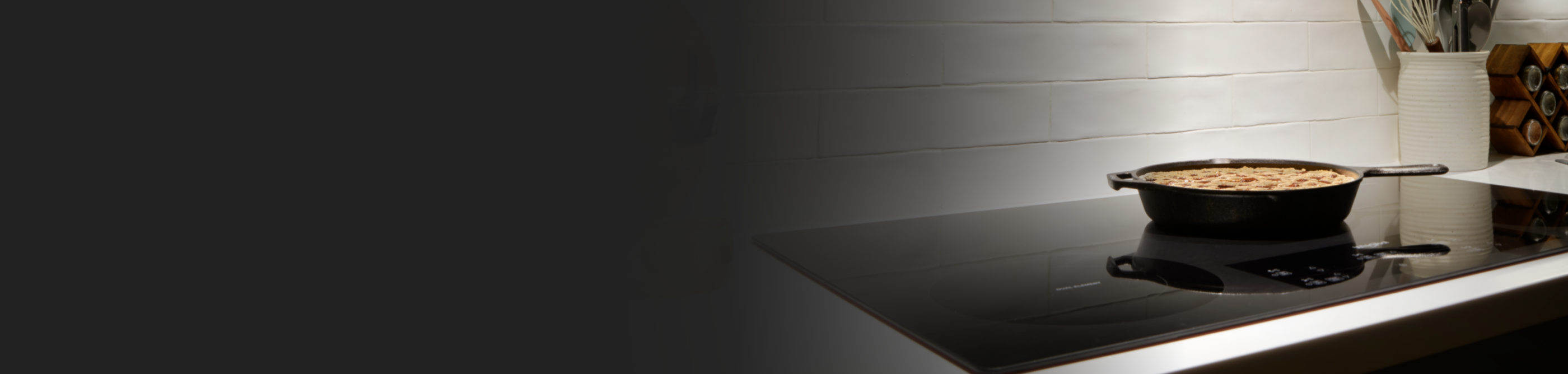 A cast iron pan on a black ceramic glass cooktop.