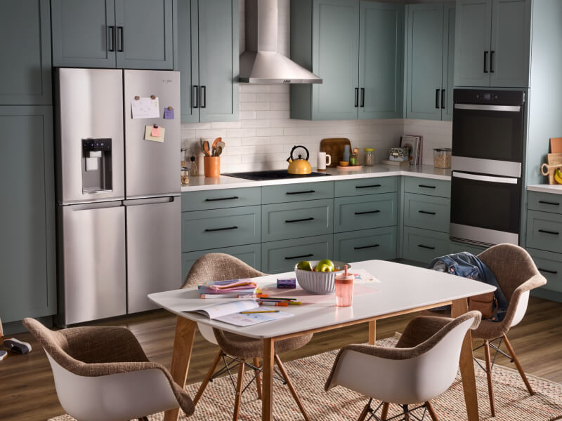 A kitchen with stainless steel appliances and a double wall oven