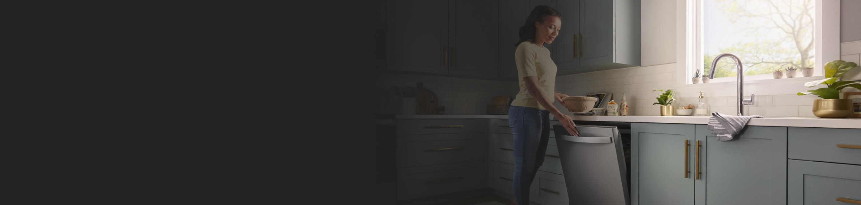 A person opening a Whirlpool® Dishwasher in a modern kitchen