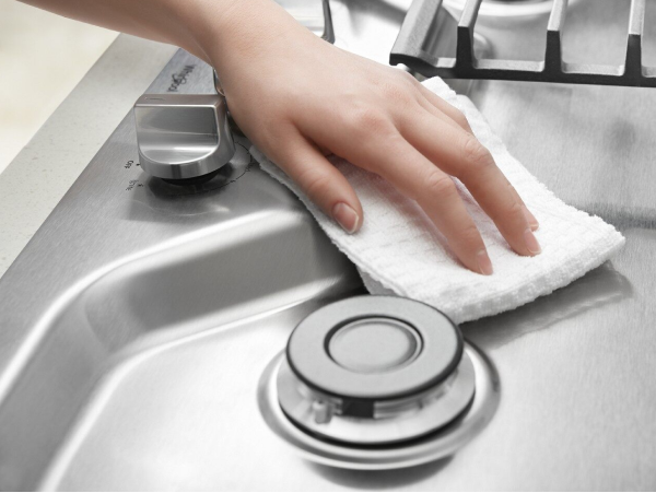 Hand wiping down stovetop