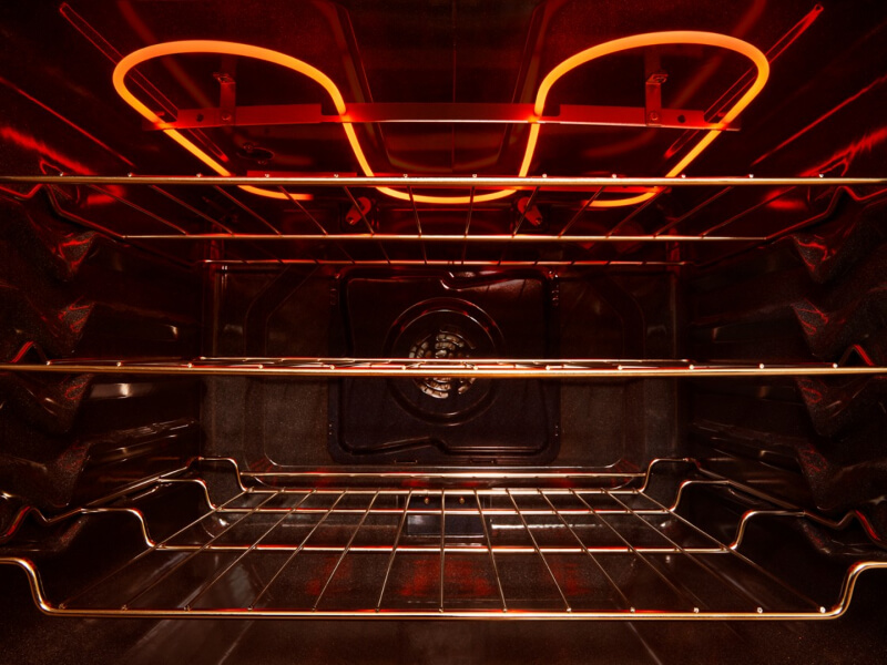 The inside of an oven with three racks The inside of an oven with three racks