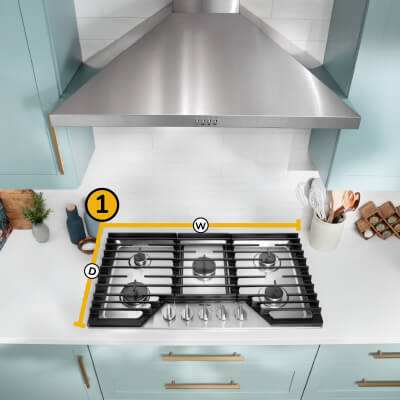 A Whirlpool® Cooktop below a Whirlpool® Range Hood with a number one