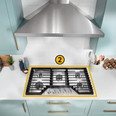 A Whirlpool® Cooktop below a Whirlpool® Range Hood with a number two