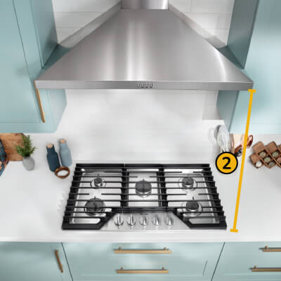 A Whirlpool® Cooktop below a Whirlpool® Range Hood with a number two