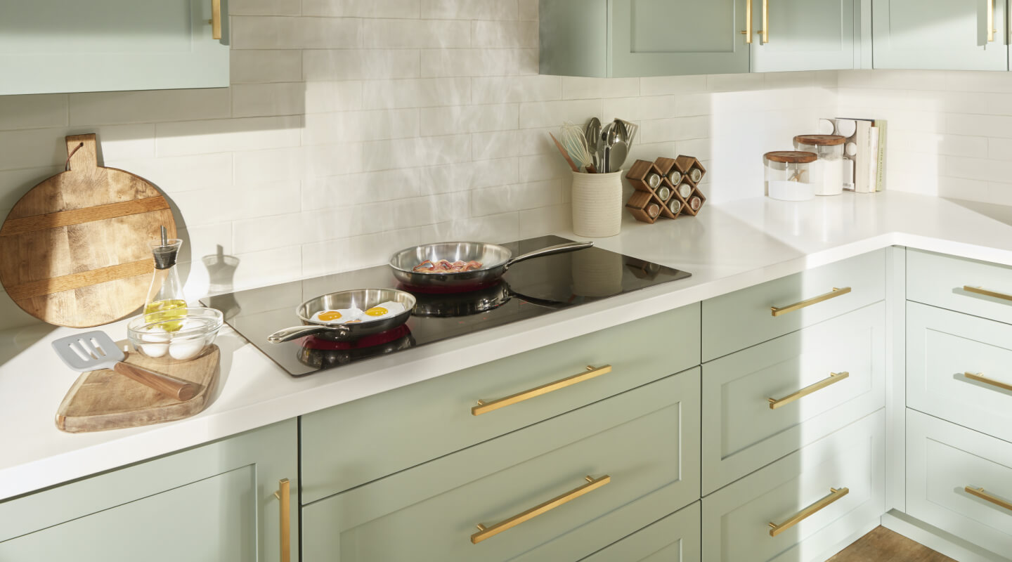 Items cooking on a Whirlpool® Cooktop