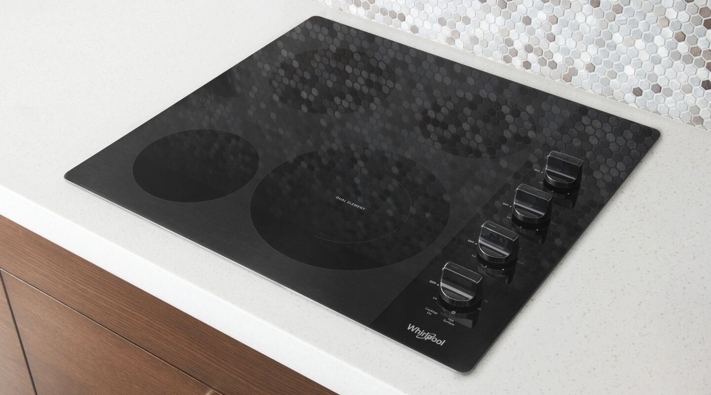 Top view of Whirlpool® cooktop set into white countertop