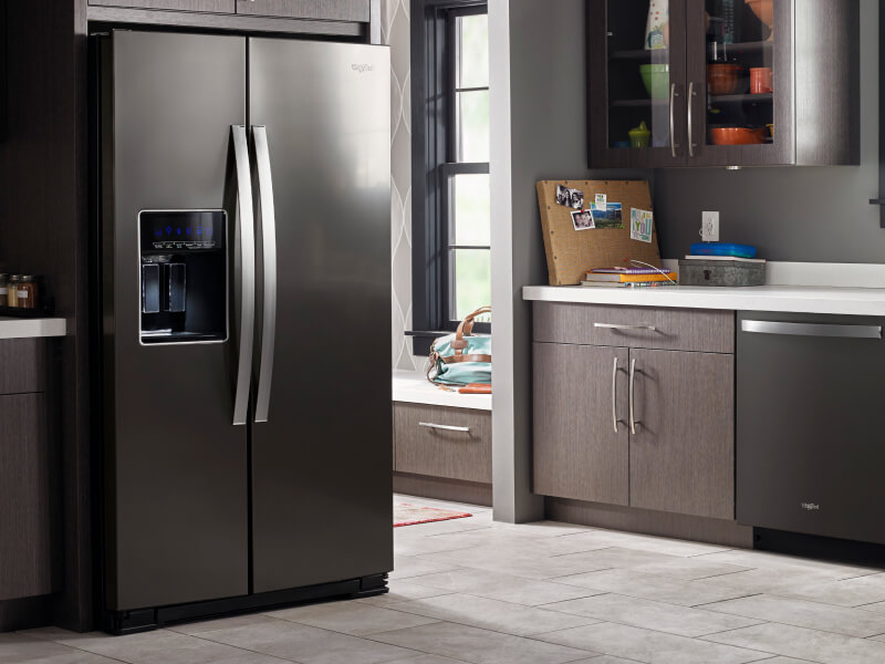 A darker kitchen with a black Whirlpool® Refrigerator and dishwasher A darker kitchen with a black Whirlpool® Refrigerator and dishwasher