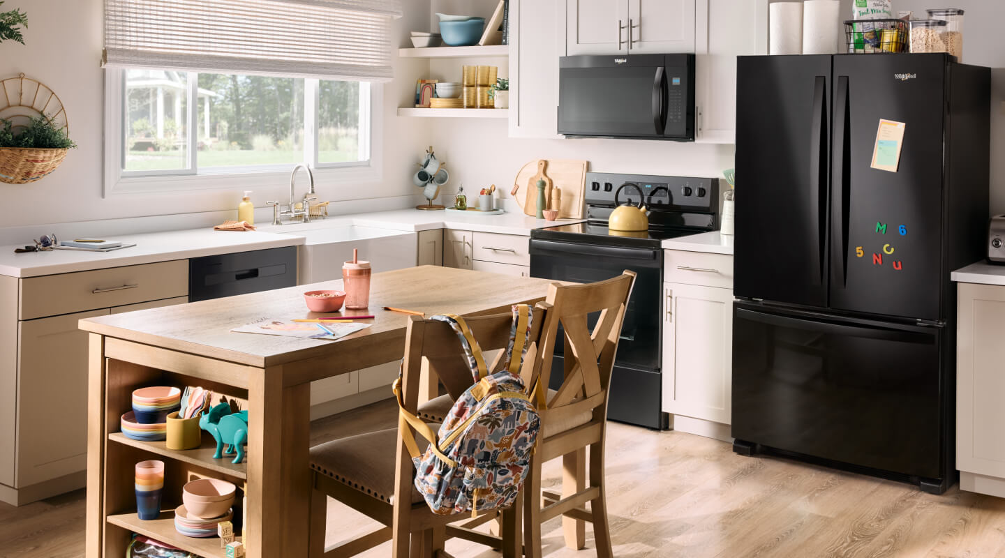 A kitchen with a suite of black Whirlpool® Appliances A kitchen with a suite of black Whirlpool® Appliances