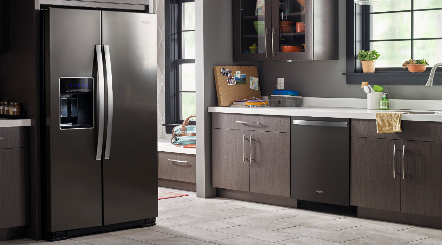 A darker kitchen with a black Whirlpool® Refrigerator and dishwasher A darker kitchen with a black Whirlpool® Refrigerator and dishwasher