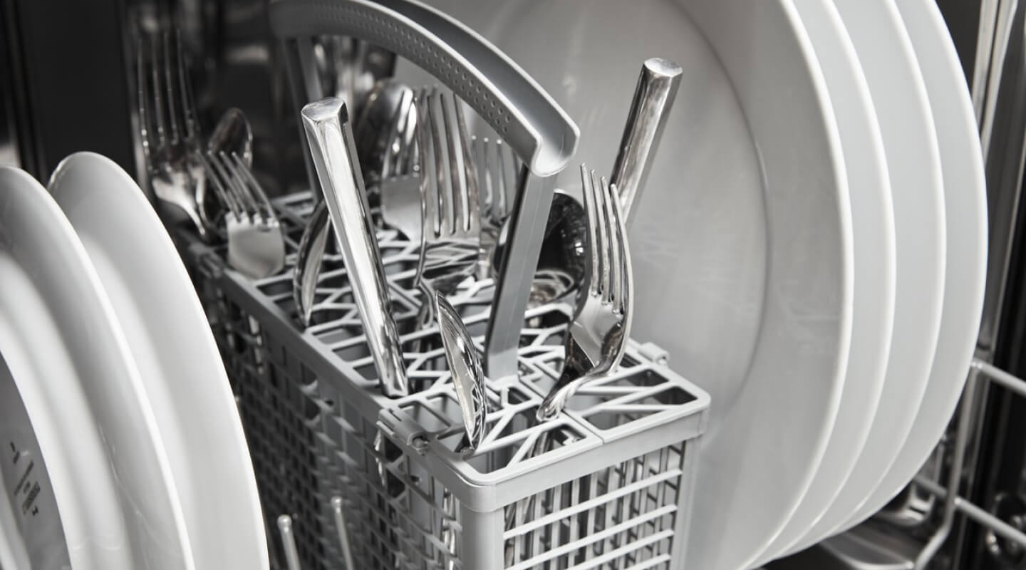 Clean silverware in a dishwasher basket
