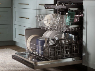 Open dishwasher full of dishes and utensils