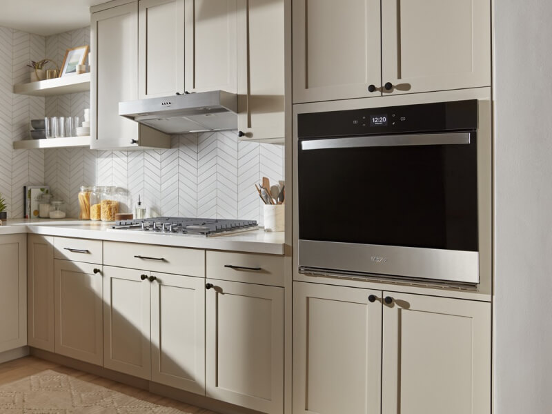 A Whirlpool® Single Wall Oven inside a beige and white kitchen