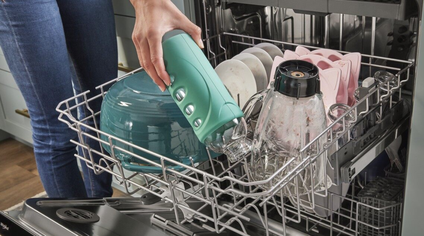 A person unloading a dishwasher
