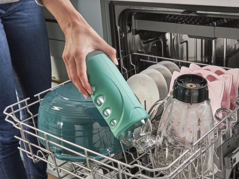 A person unloading a dishwasher