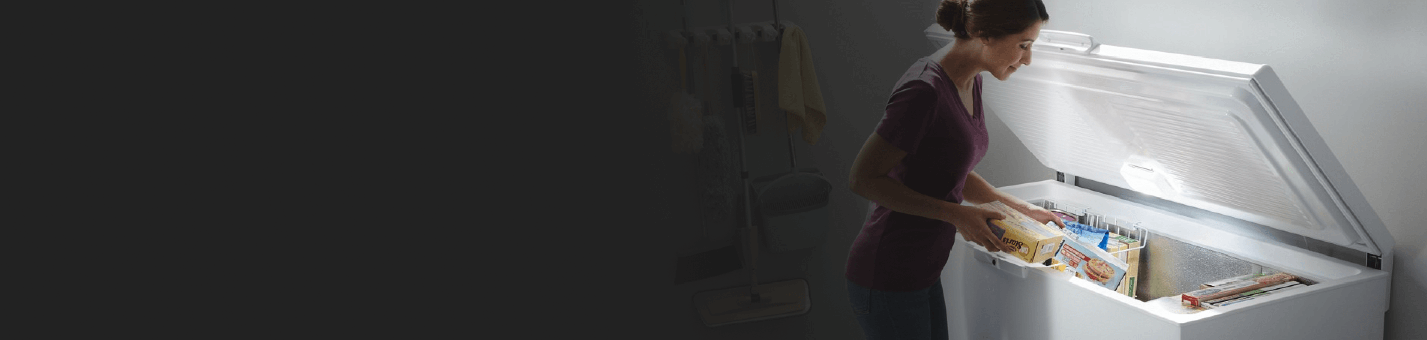 Person taking food out of an open chest freezer