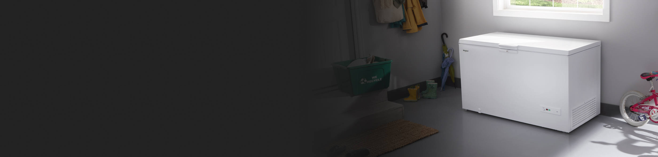 A white chest freezer sitting in a basement