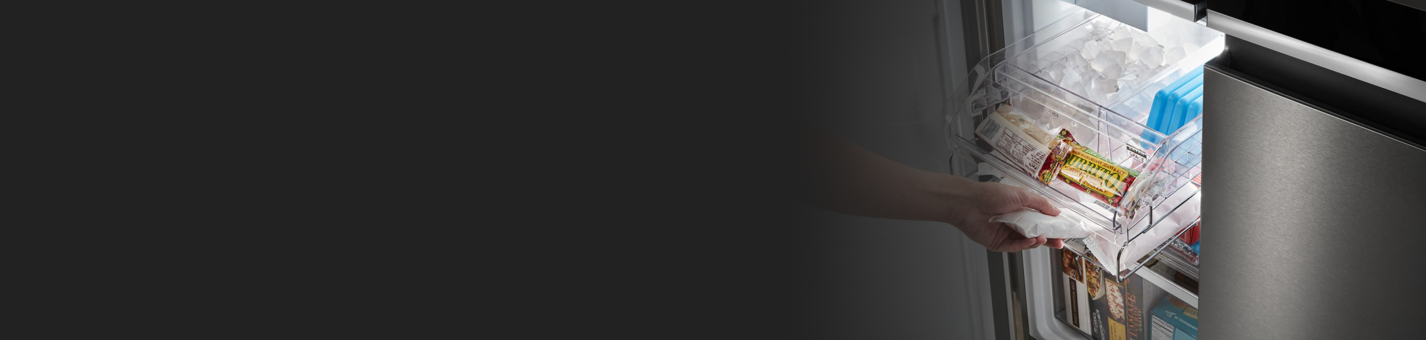 Person sliding out organization bin in freezer compartment