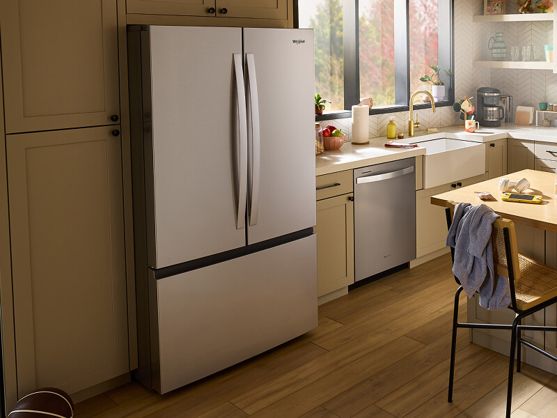 Stainless steel Whirlpool® French Door Refrigerator in a cream-colored kitchen