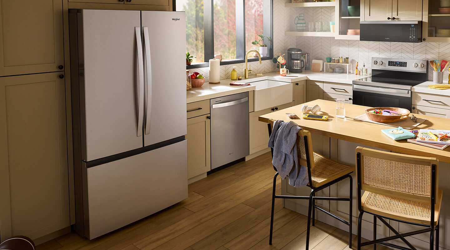 Stainless steel Whirlpool® French Door Refrigerator in a cream-colored kitchen