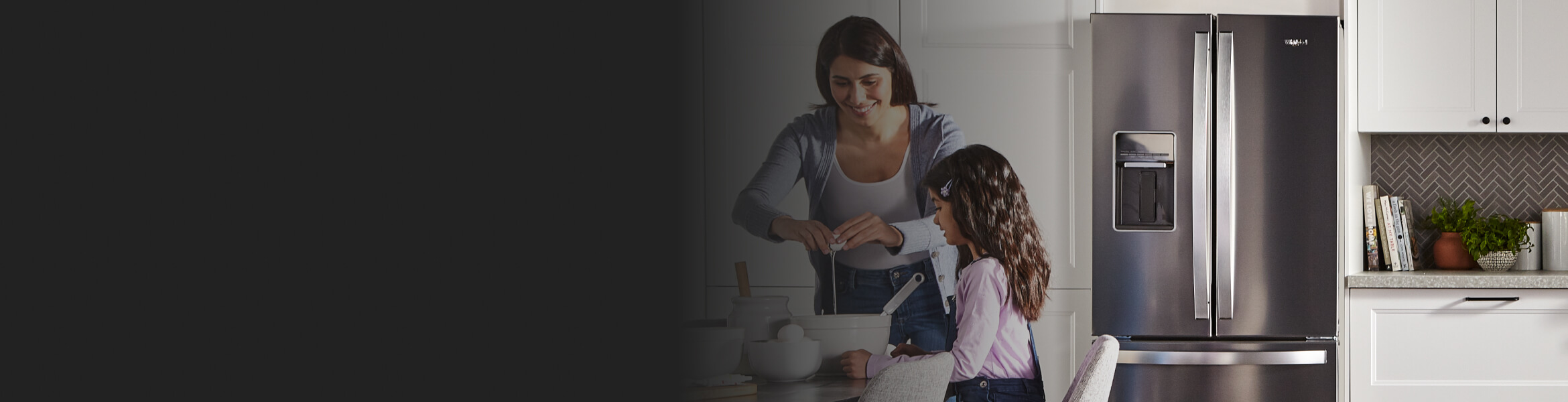 Woman and child cooking in front of a French door refrigerator