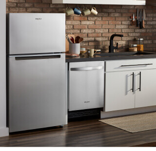 A stainless steel Whirlpool® refrigerator and dishwasher in a kitchen