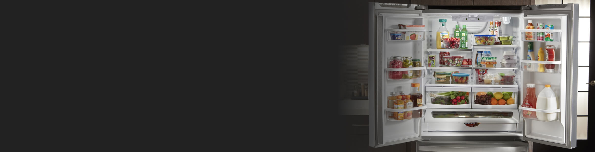 Side-by-side refrigerator doors open with a mix of colorful groceries inside