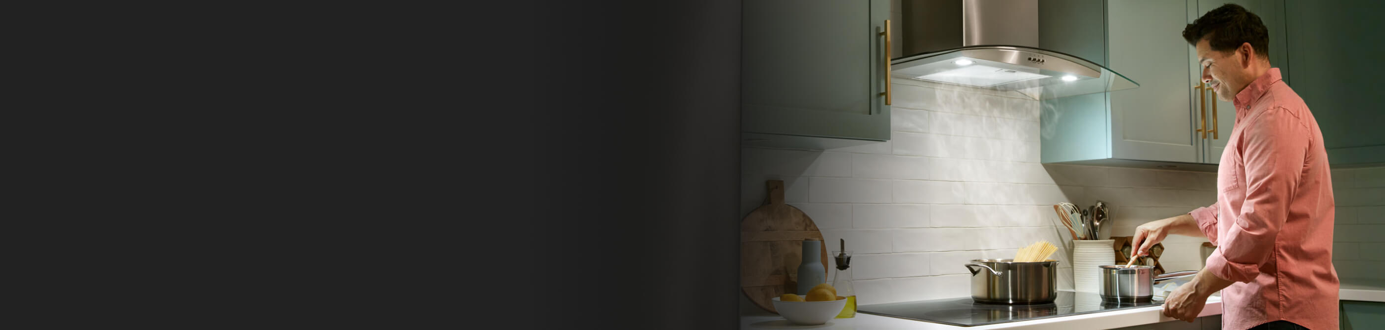 A range hood drawing the steam up from a pot of boiling pasta