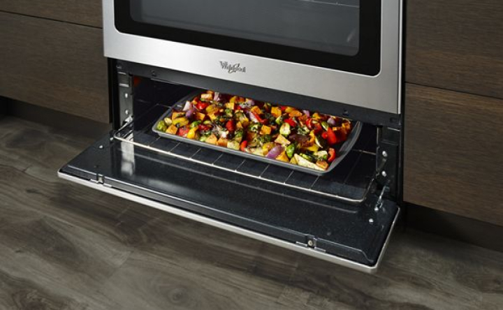 A sheet pan of vegetables in an under-oven broiler