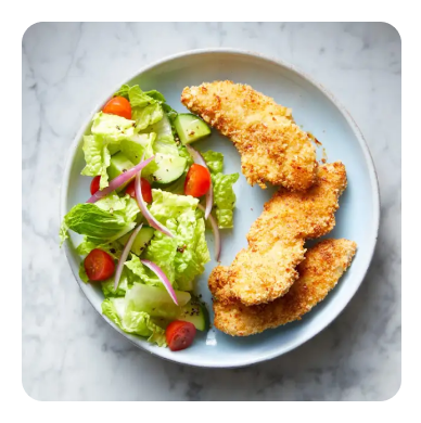 Breaded chicken tenders and salad on a plate