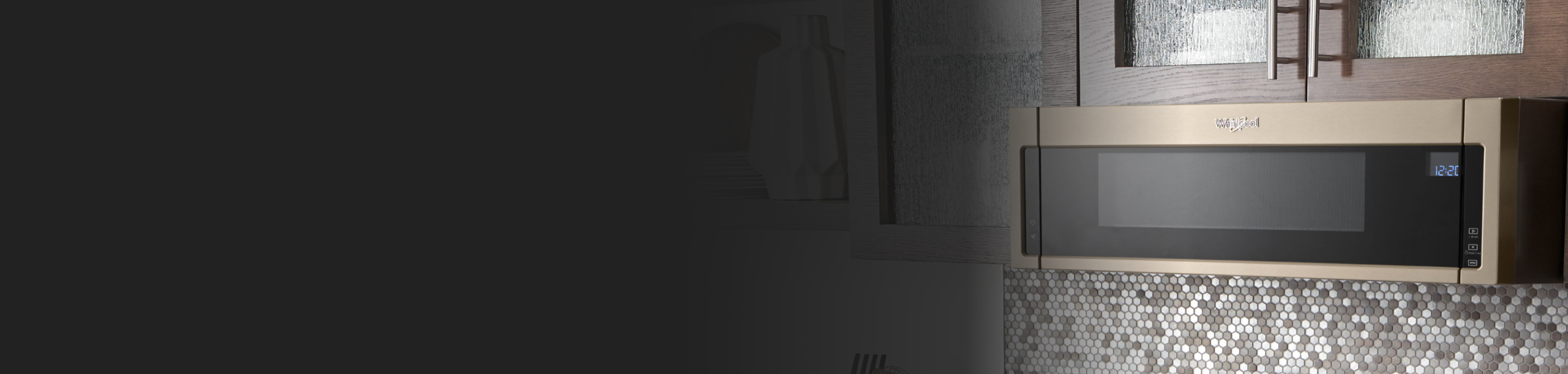 Bronze Whirlpool® low profile microwave below brown cabinetry