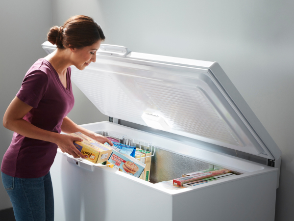 Woman taking items from a deep freezer