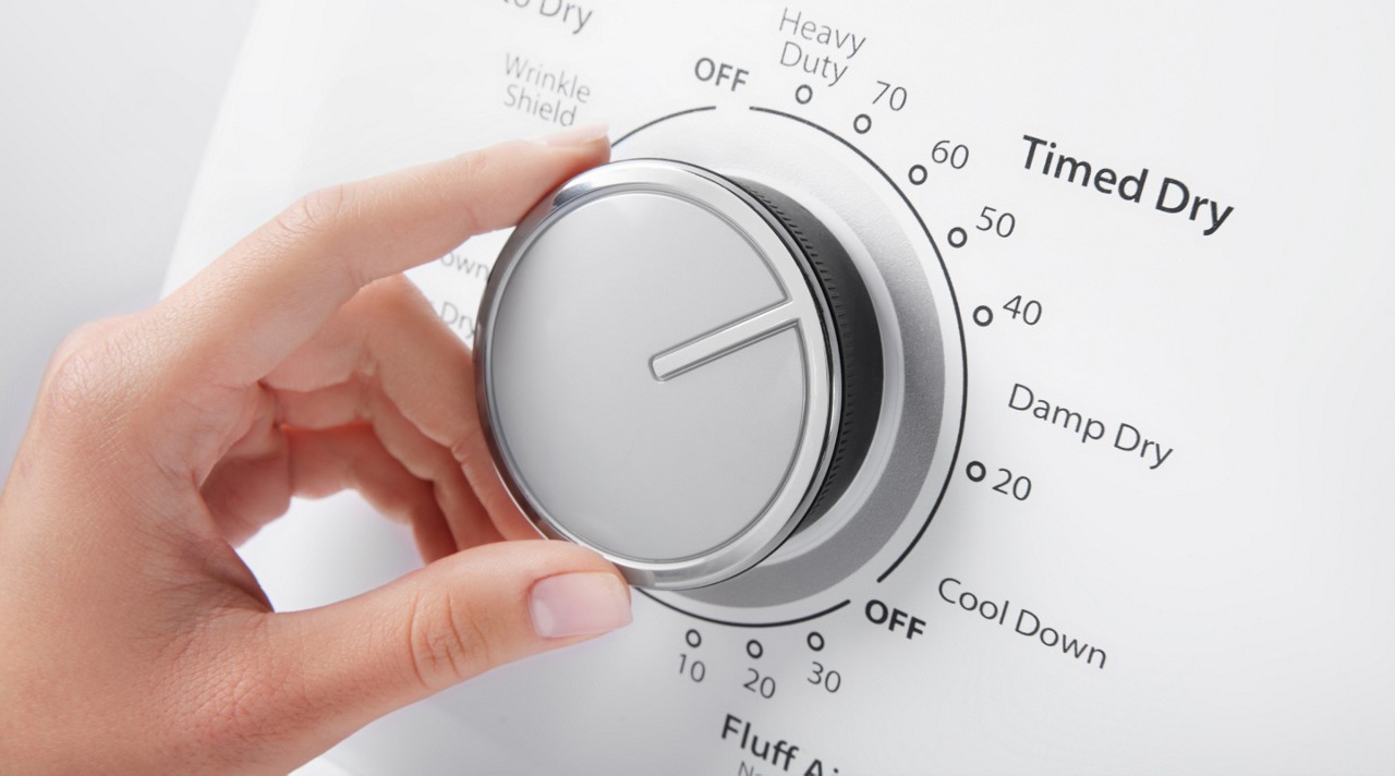 Person selecting a dryer cycle on a Whirlpool® Dryer Person selecting a dryer cycle on a Whirlpool® Dryer