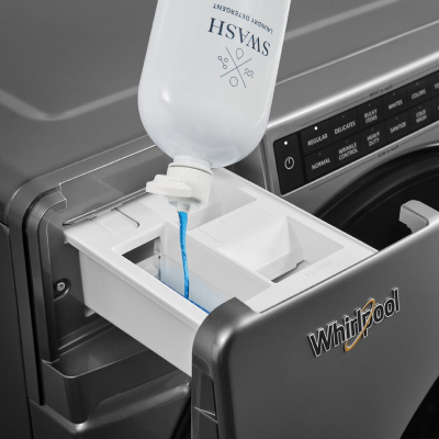 Swash® detergent pouring into a detergent dispenser
