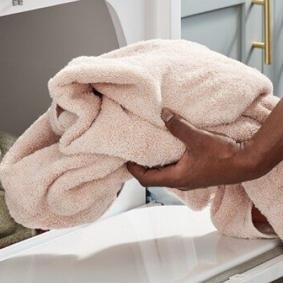 Hand pulling a towel out of dryer