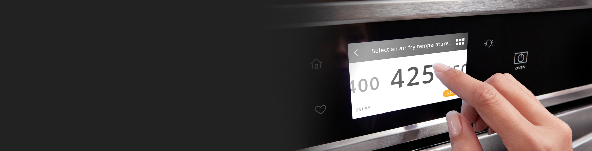 Finger touching digital display on oven