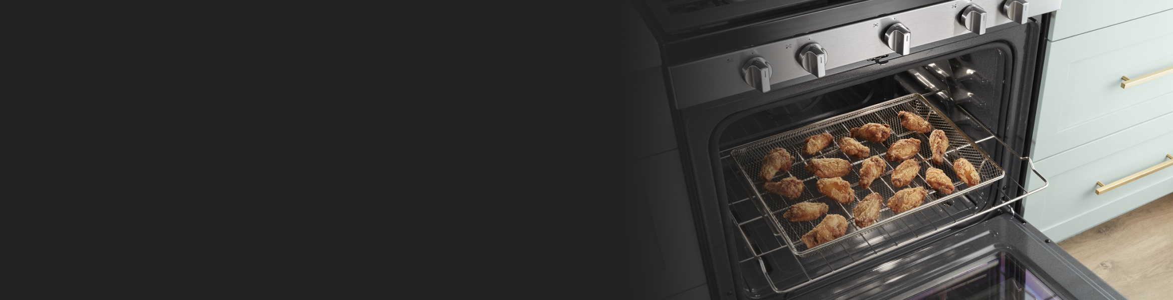 Air fried chicken sitting in an air fryer basket on an oven rack 