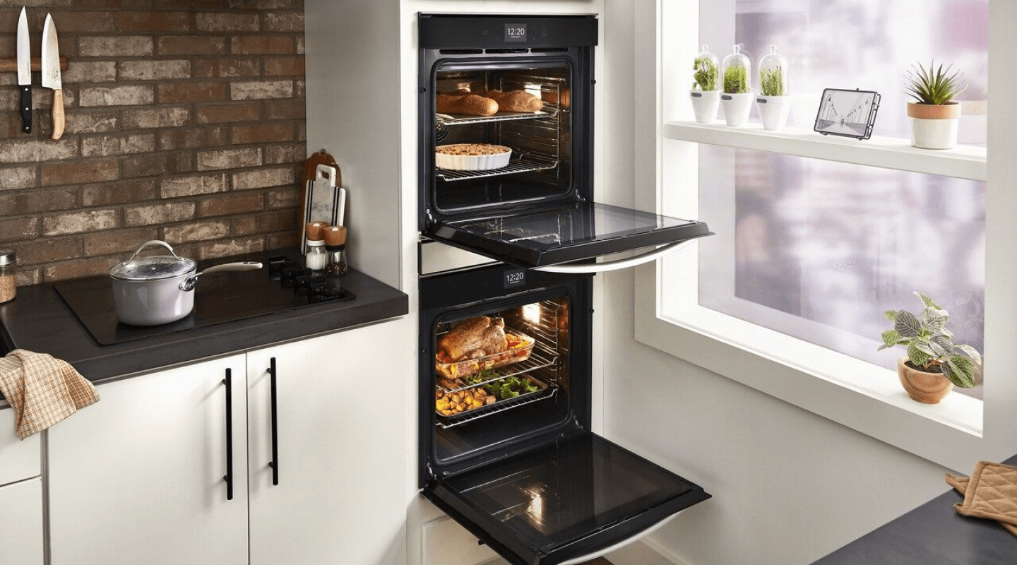 Double wall ovens with doors open displaying various dishes