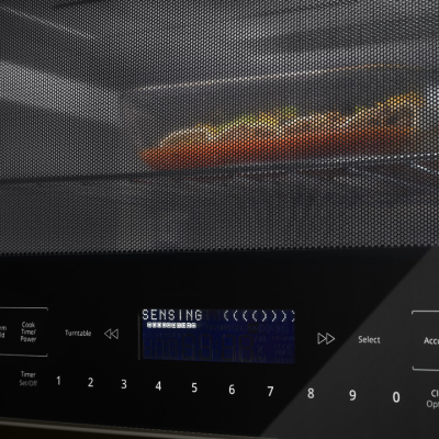 Closeup of a tray of food heating in a microwave