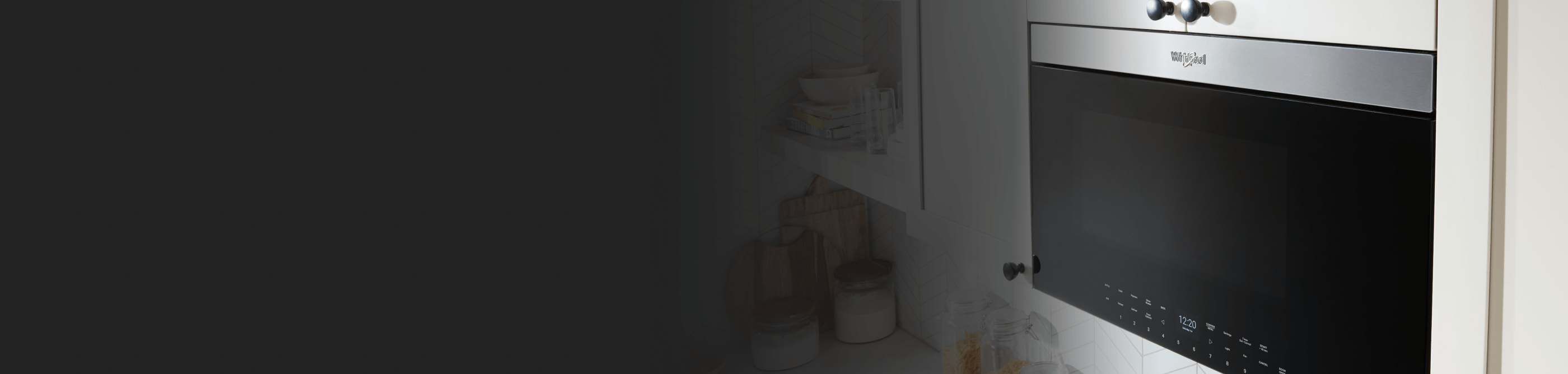 Black and silver Whirlpool® over-the-range microwave with a Flush Built-in Design