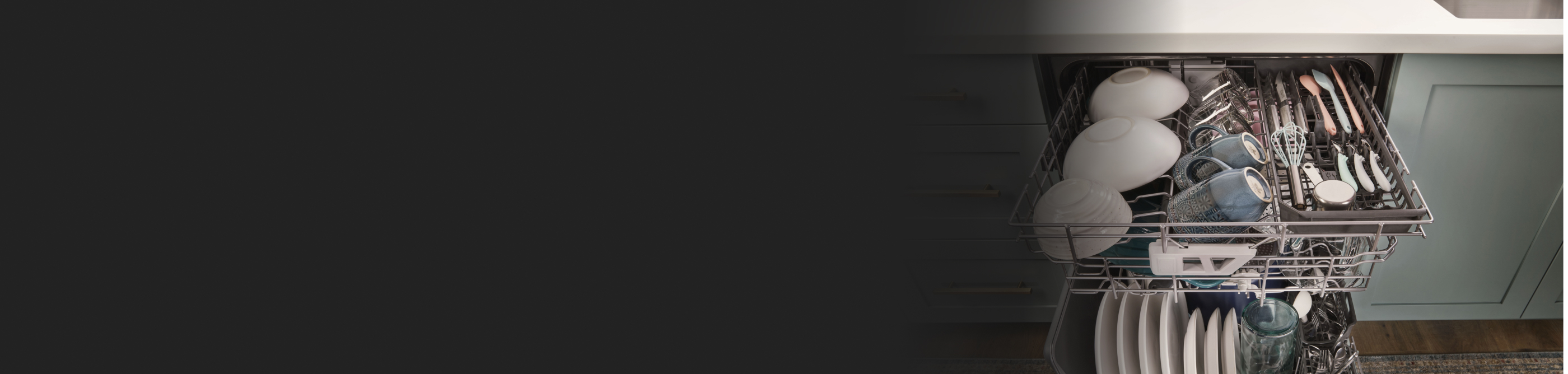 Open dishwasher with dishes on each rack