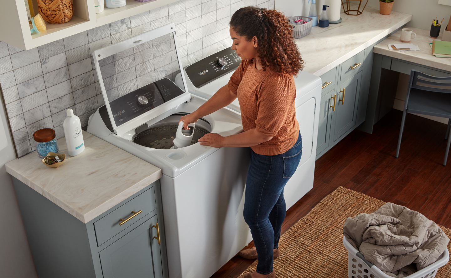 Person removing agitator from washing machine Person removing agitator from washing machine