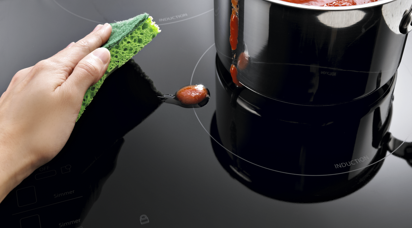 Removing spills from the stove top Removing spills from the stove top