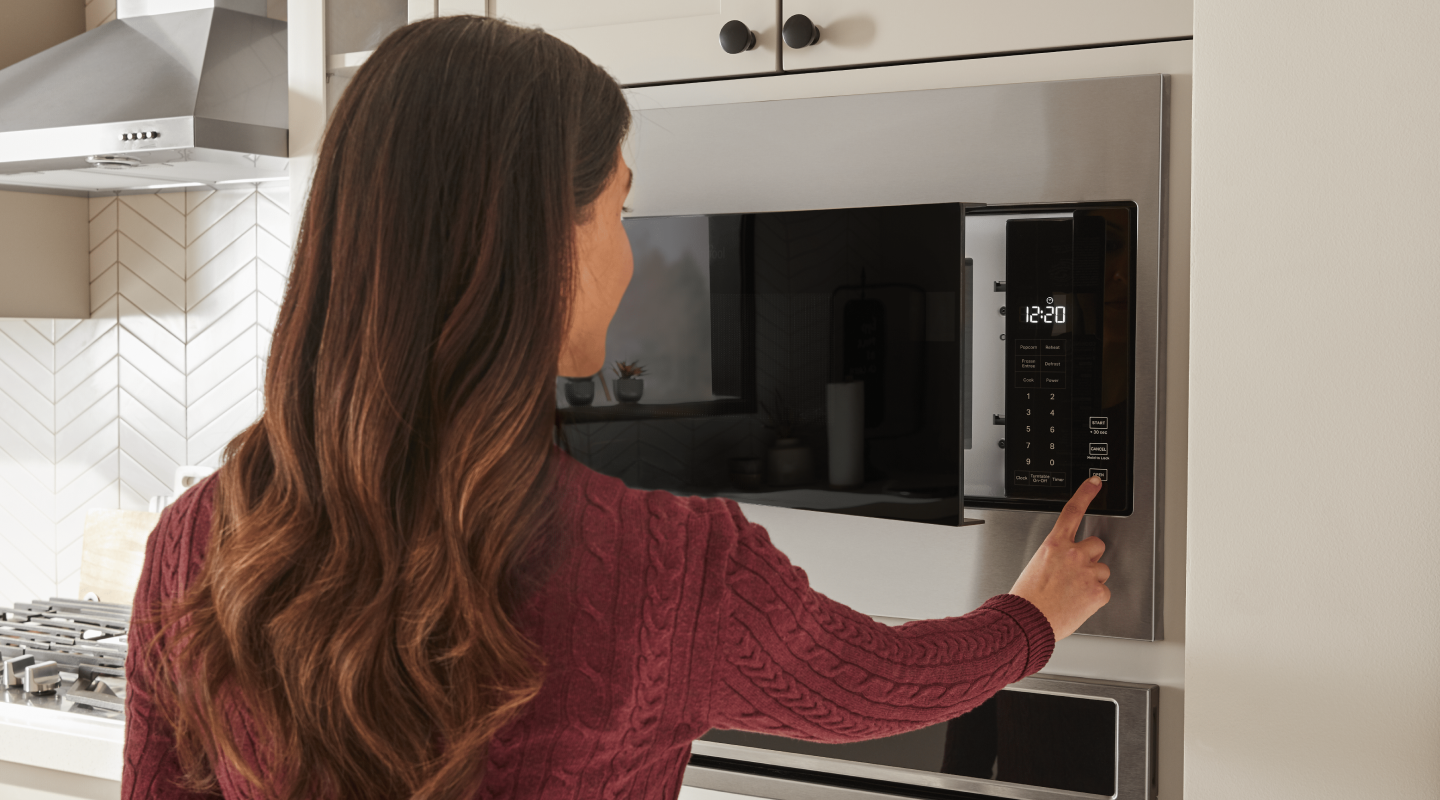 Person setting microwave temperature