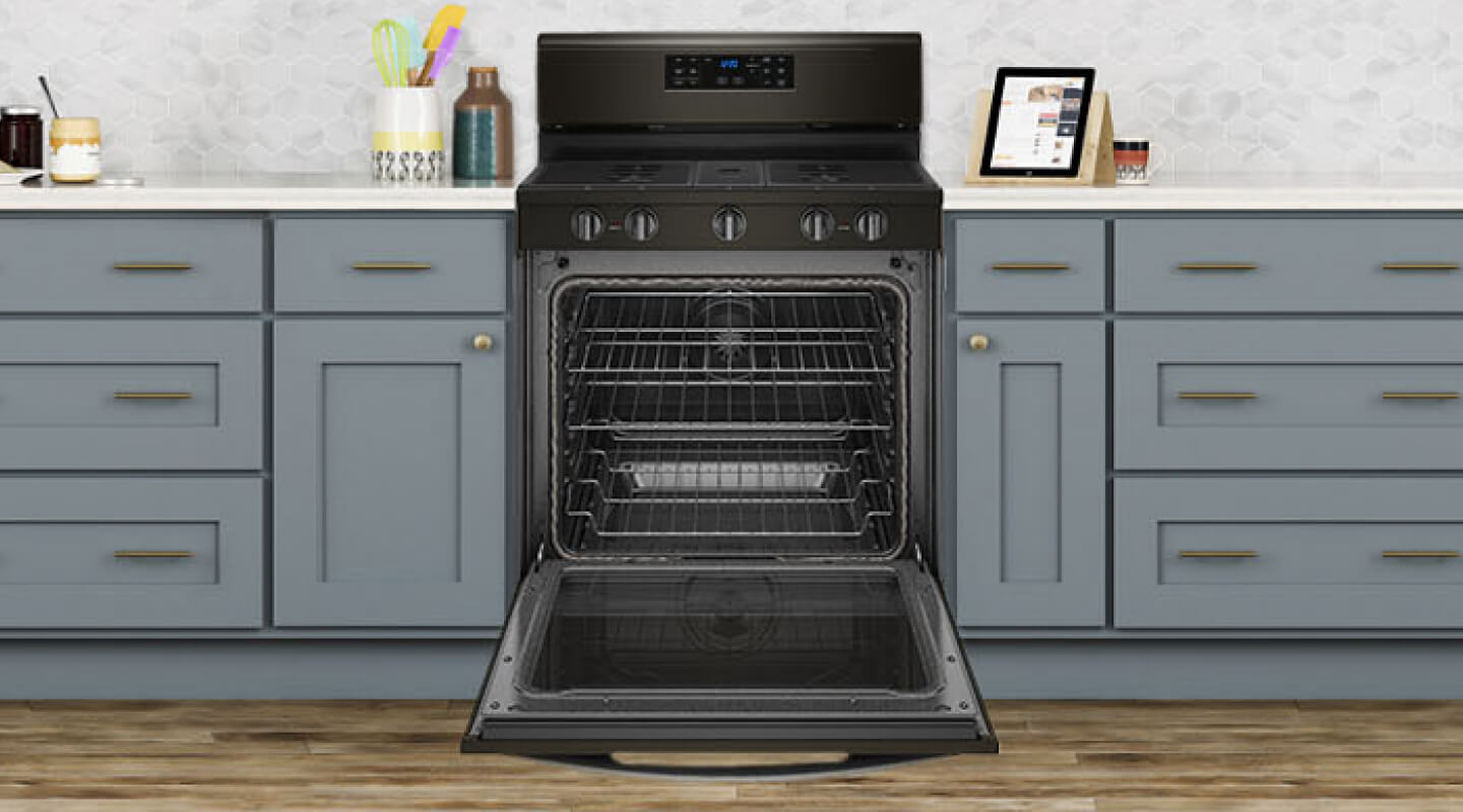 An open oven with multiple oven racks An open oven with multiple oven racks