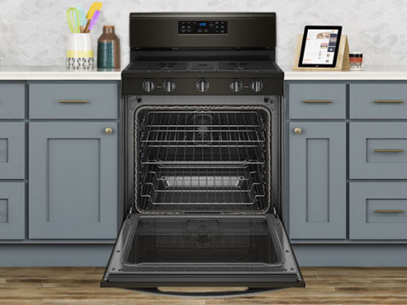 An open oven with multiple oven racks An open oven with multiple oven racks