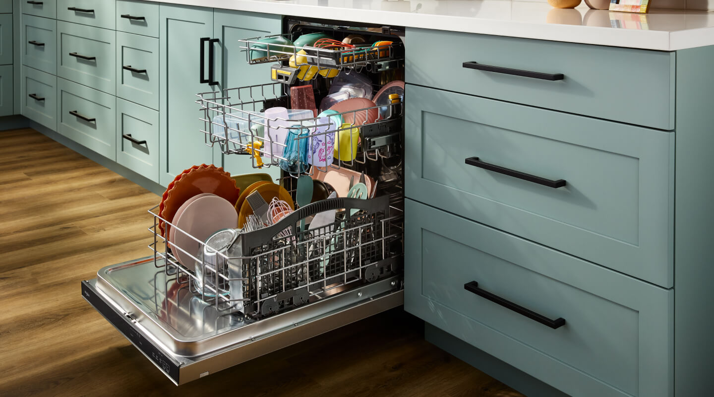 Open Whirlpool® Third Rack Dishwasher with all three rows loaded with dishes