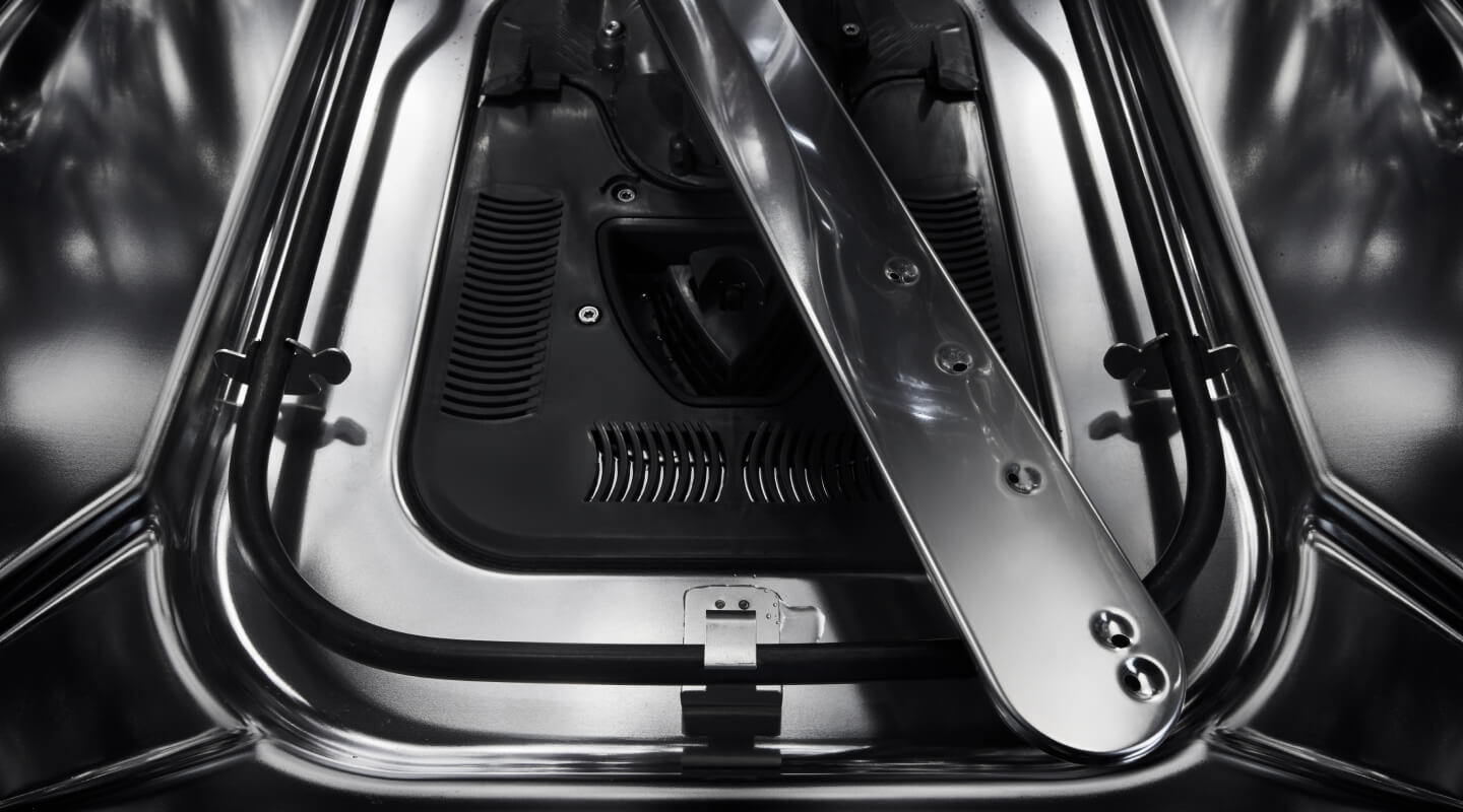 Close-up of a spray arm inside a dishwasher